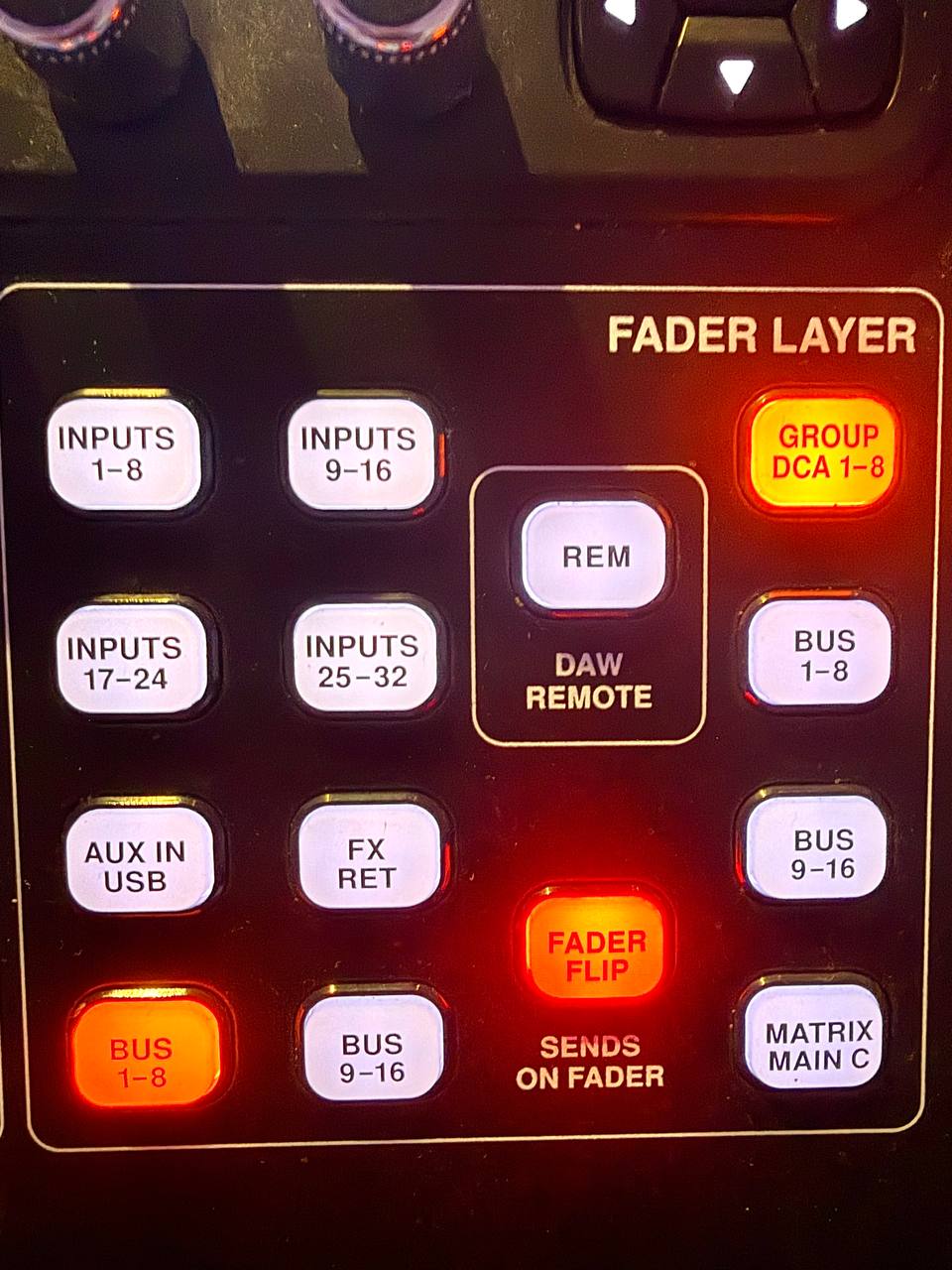 Close-up of the fader layer controls with BUS 1–8 and FADER FLIP illuminated